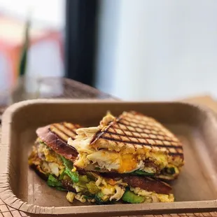 The Meg-Hen is filled with roasted chicken red pepper aioli, avocado, spinach, and cheddar cheese on country white bread!