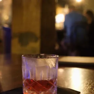a glass of alcohol on a table