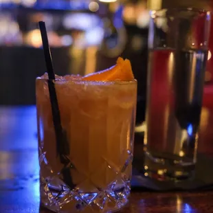 a glass of orange juice and a glass of water