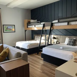 a bedroom with bunk beds and a couch