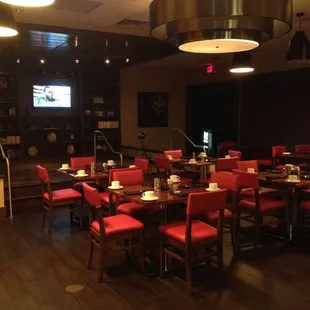 a dining room with red chairs