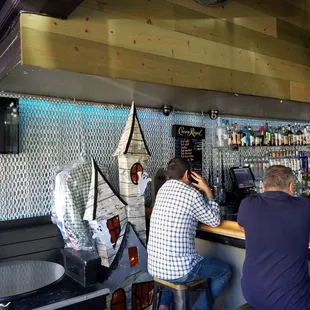 two men sitting at a bar