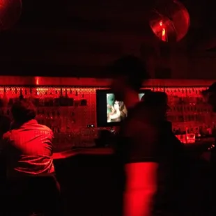 people sitting at a bar watching a movie
