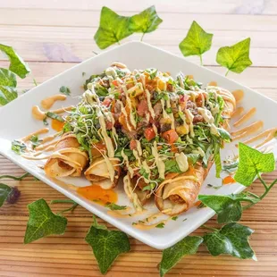 V&apos;s Rollin Sweet Tacos 4 rolled Tacos topped w/ spring mix lettuce, pineapple cucumber salsa, avocado cream &amp; sweet chili sauce