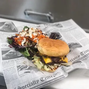 Chuckanut burger with a side salad.