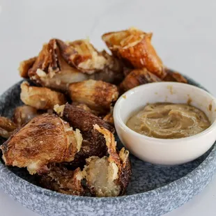 a plate of fried chicken wings and dipping sauce