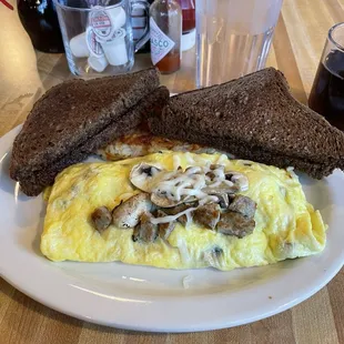 Omelet with mushrooms and provolone cheese and Rye toast already buttered