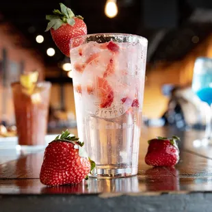 a glass of ice and strawberries