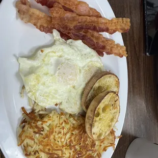 2 eggs with hash browns English muffin and bacon sooo yum.