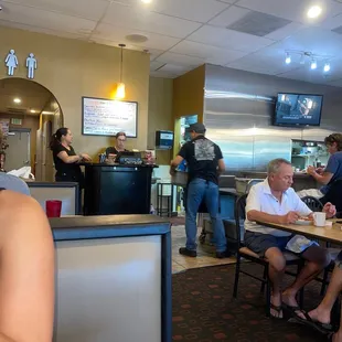 a woman sitting at a table in a restaurant