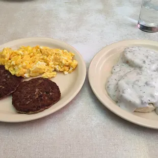 Half order of biscuits and gravy, scrambled eggs with cheese, and sausages patties.