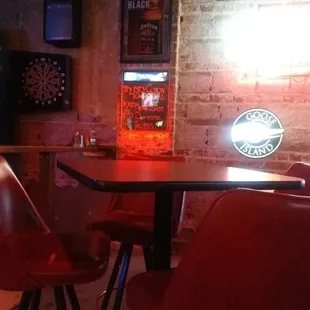 a bar with red chairs