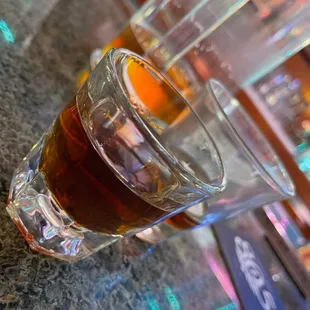 a glass of beer on a bar counter