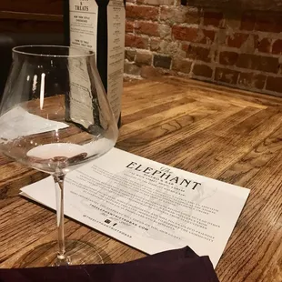 a wine glass and menu