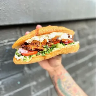 Perseus - chermoula chicken, white bean spread, kalamata tapenade, feta, lettuce, tomato, shaved red onion, bolillo from Mexicantown bakery.