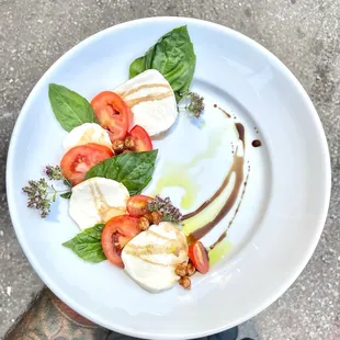 Caprese Salad - tomato two ways, fresh mozzarella, basil, crispy chickpeas, balsamic, herb oil.