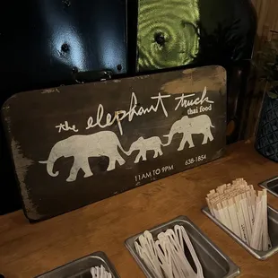 a wooden sign and trays of toothpicks