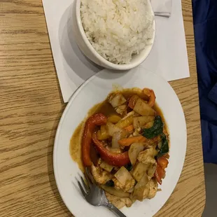 Spicy Chicken with rice served with the dish.