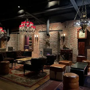 a living room with a fireplace and chandelier