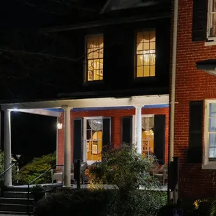 Can you find Chef Dan Wecker joyfully chatting with some guests in one of the first floor dining rooms?