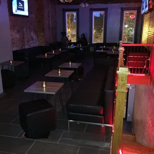 a dimly lit restaurant with tables and benches