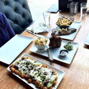 Loaded tots, pork shank, steak and fries