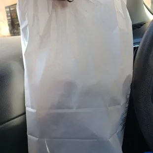 a person holding a paper bag