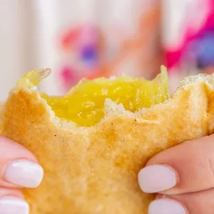 a woman holding a piece of bread
