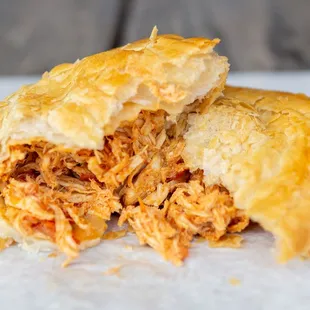 a close up of a chicken empanada