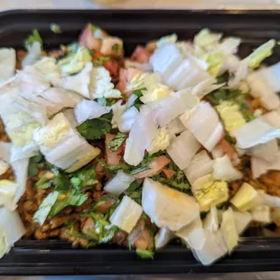 White rice, red pinto beans, beef, pico de gallo, and lettuce bowl