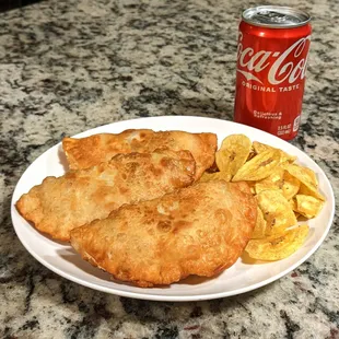 a plate of food and a can of coke