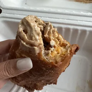 a hand holding a pastry