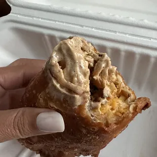 a hand holding a pastry