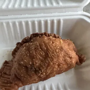 a piece of food in a styrofoam container