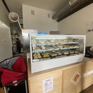 Countertop with selection of empanadas available warm, plus the pricing below.