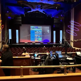 two people sitting in front of a projector screen