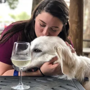 a woman kissing a dog