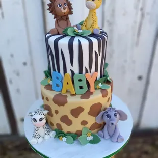 a baby shower cake with jungle animals