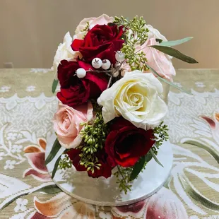 a bouquet of red and white roses