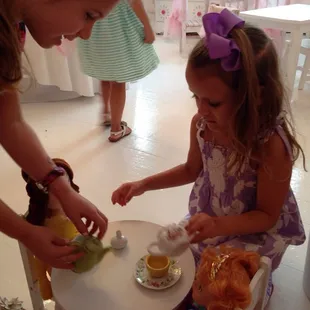 Learning the skill of pouring tea!