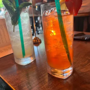 two glasses of drinks on a table