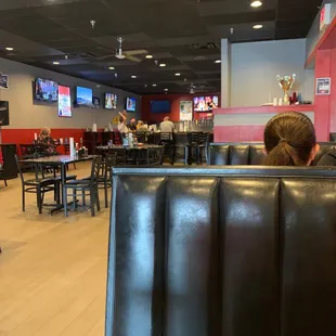 people sitting at tables in a restaurant
