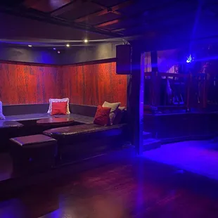 a living room with couches and a bar