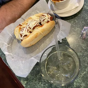 Meatball sub and cup of chili con carne.