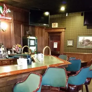 a bar with blue chairs
