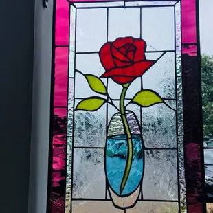 a rose in a glass vase