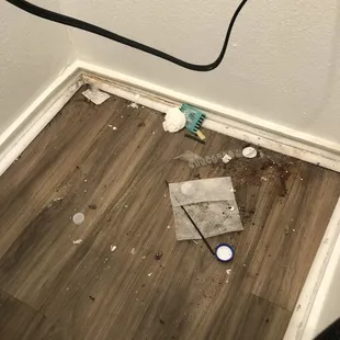 Behind washer!  They didn't clean before I moved in like they said.