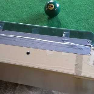 The pool table is literally being held together by duct and scotch tape... Wtf