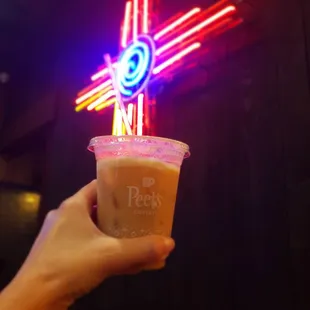 a hand holding a cup of coffee