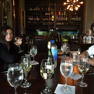 a group of people sitting at a table with wine glasses
